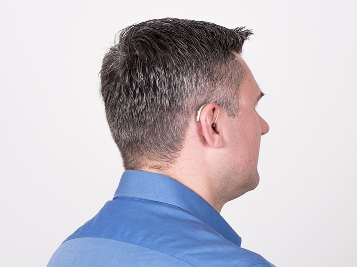man with hearing loss wearing rechargeable hearing aids