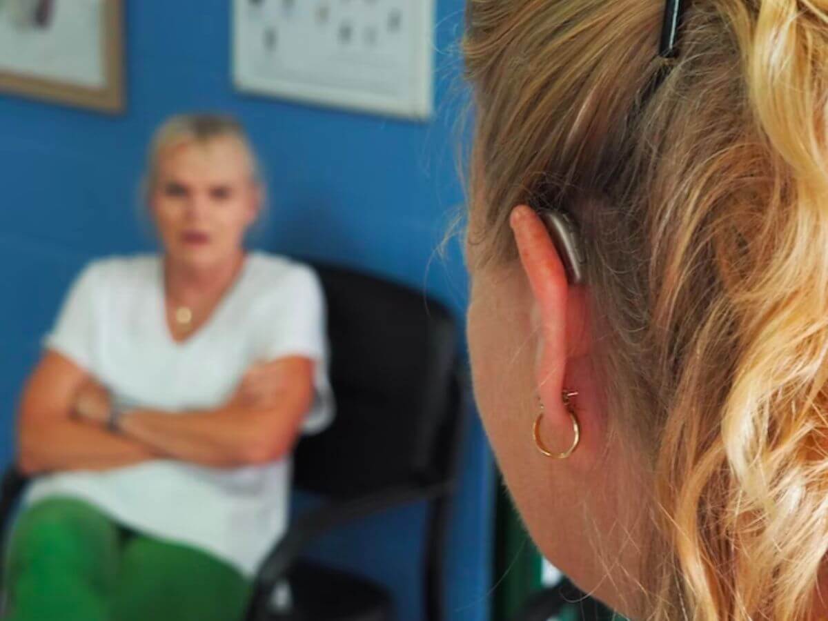 adult with hearing aids practice speaking
